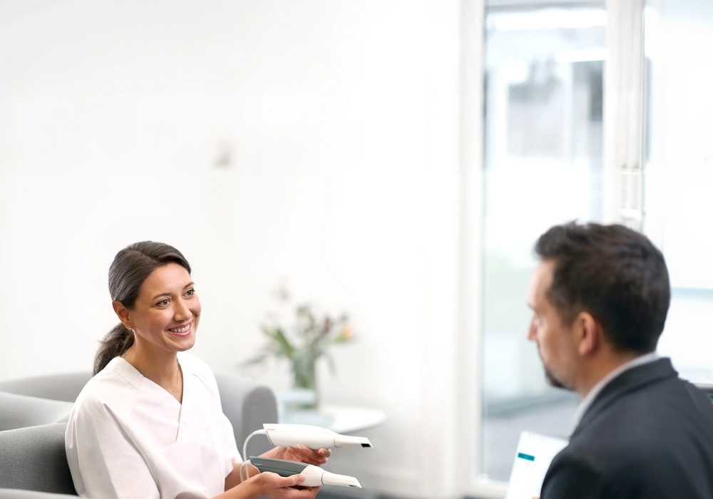 Person holding TRIOS 5 scanner